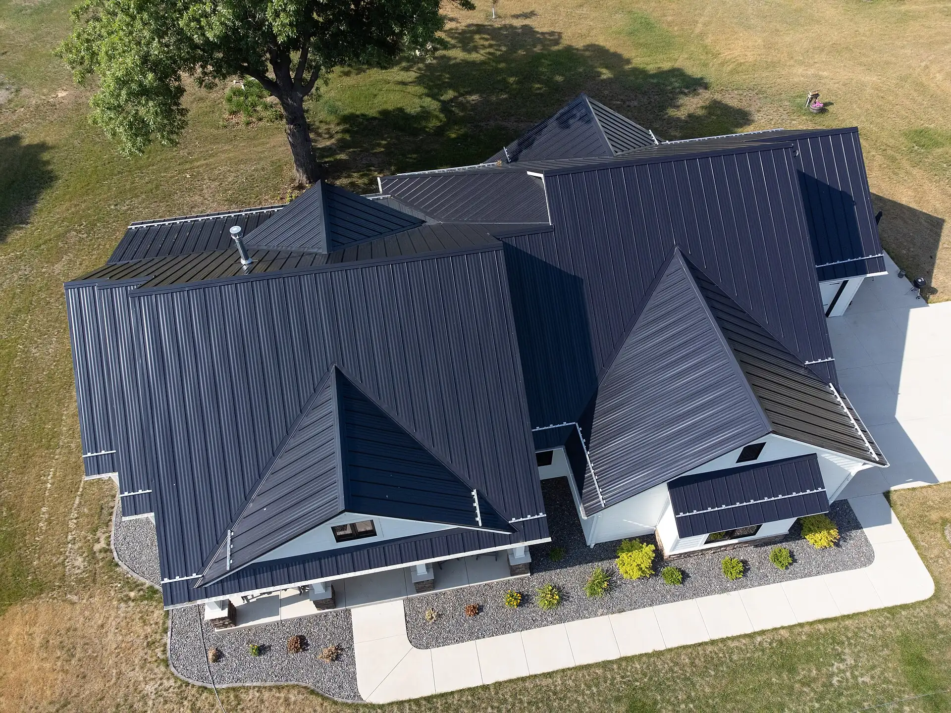 Home with a dark standing seam metal roof